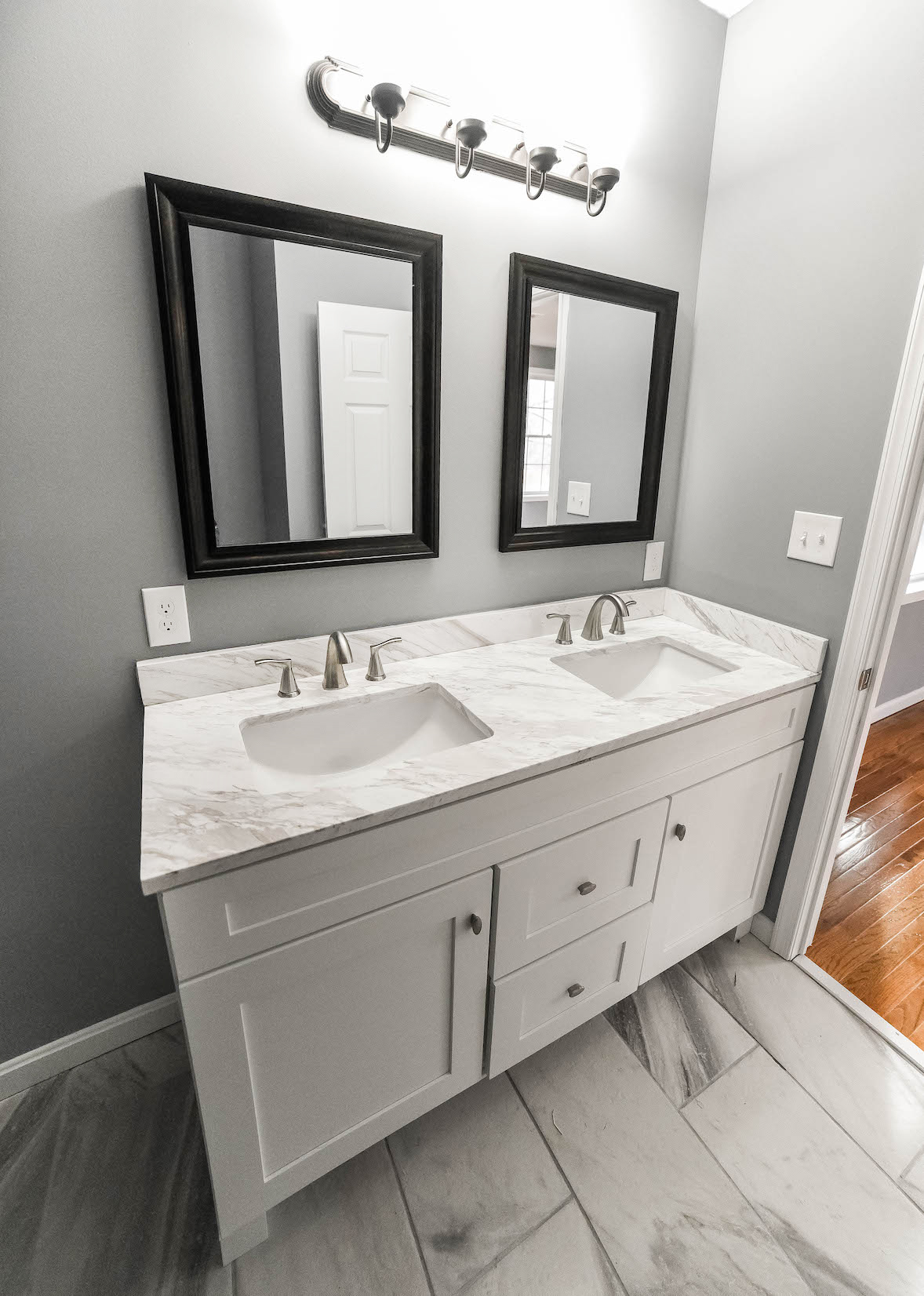 Master suite finished bathroom vanity with dual sinks and mirrors as well as excellent light for getting ready in the morning.